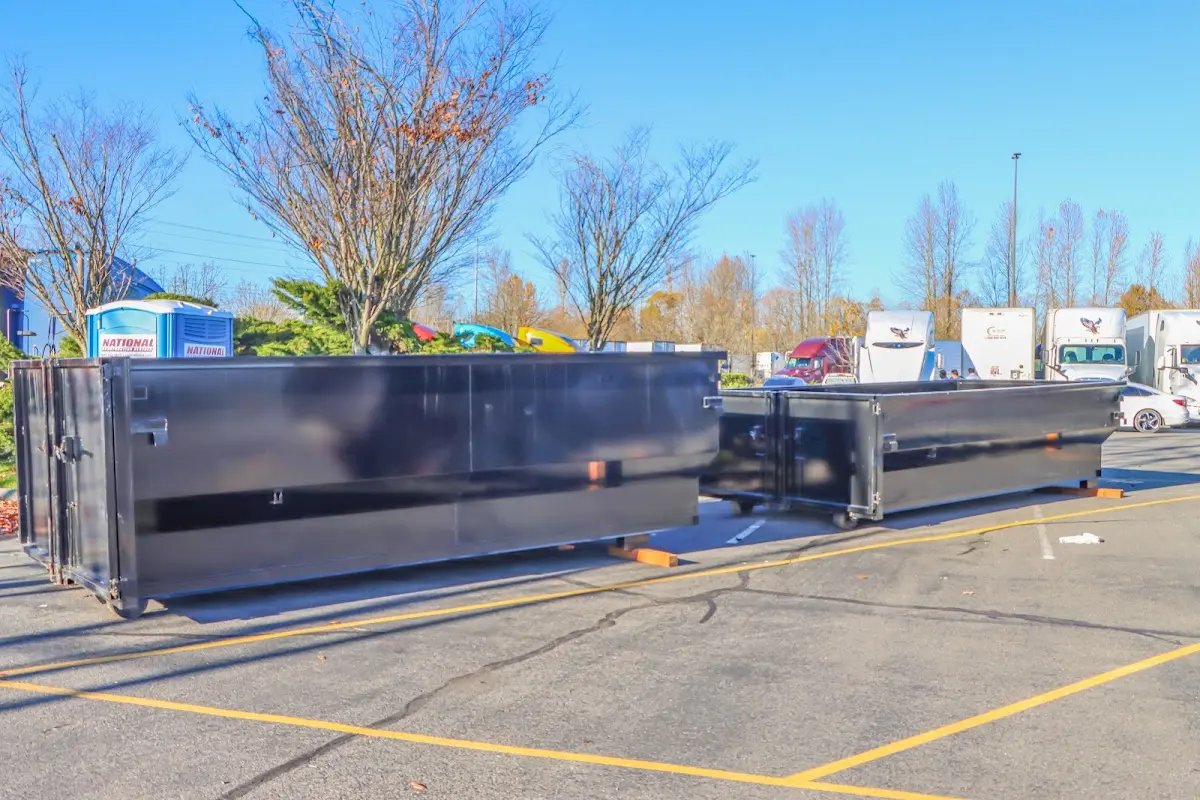 Professional dumpster rental service with roll-off container on residential driveway in Black Jack